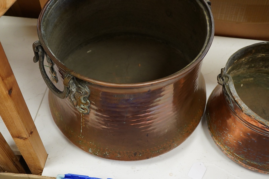 A collection of four copper vessels and another brass, largest 32cm